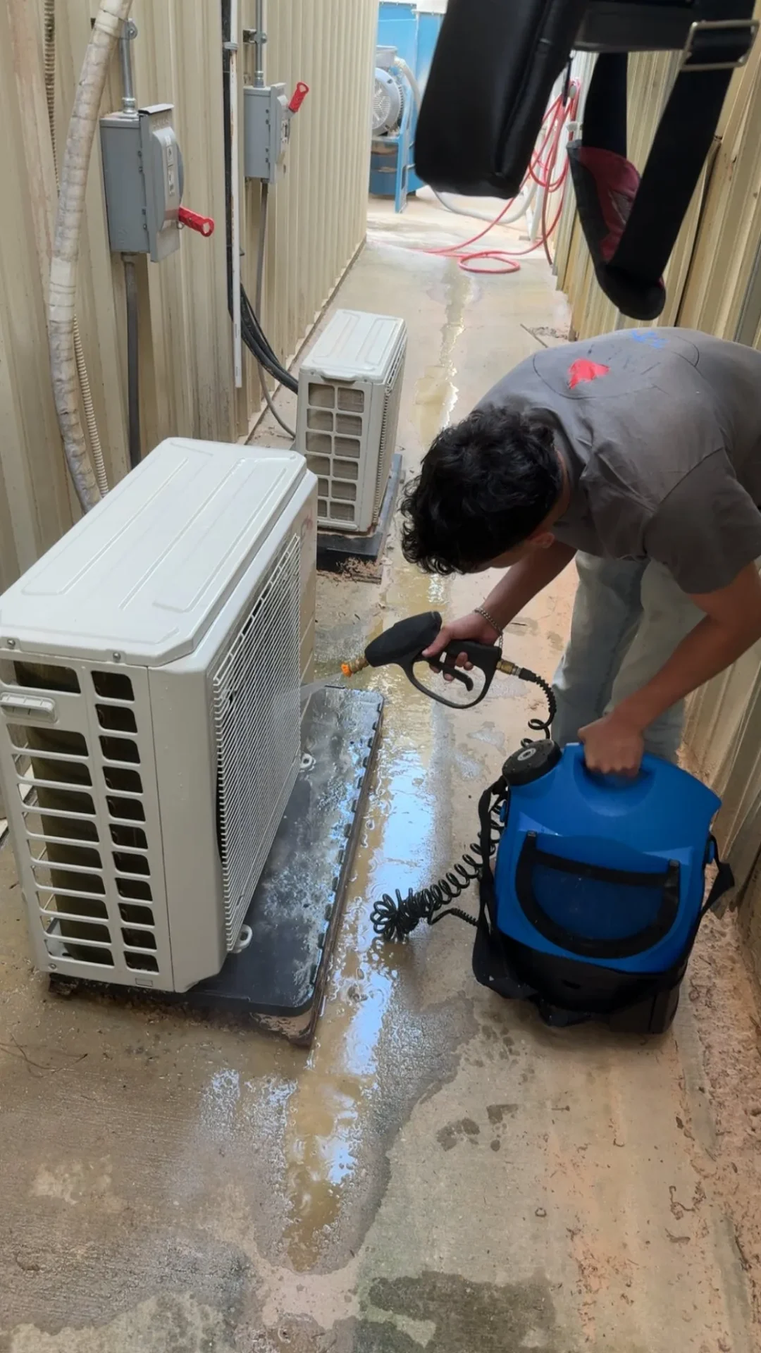 Technician servicing AC condenser in Hammond, LA
