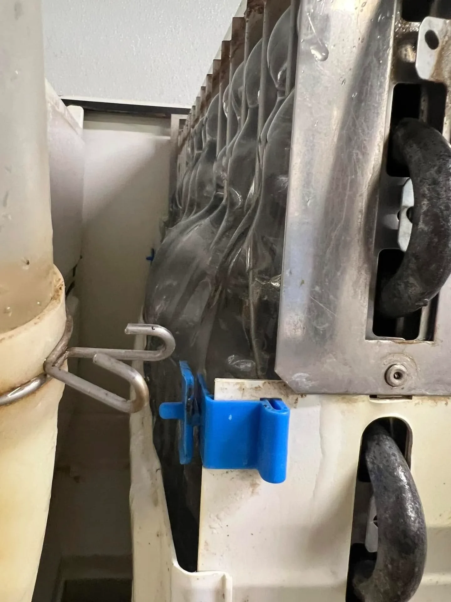 Industrial ice maker interior being repaired