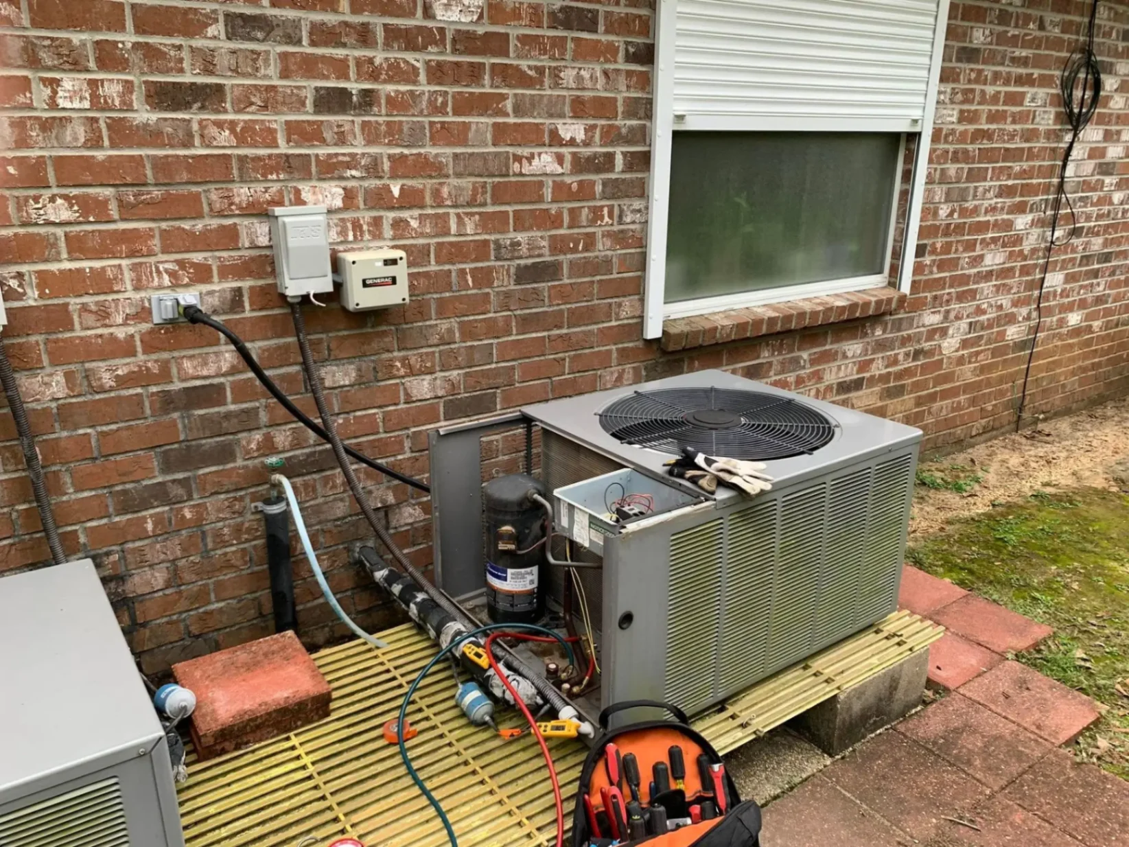 TMAC technician repairing condenser unit in Kentwood, LA